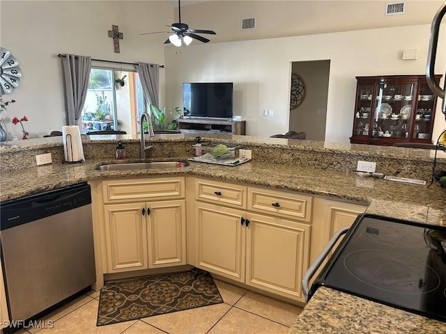 kitchen featuring sink, cream cabinets, stainless steel dishwasher, and range with electric cooktop