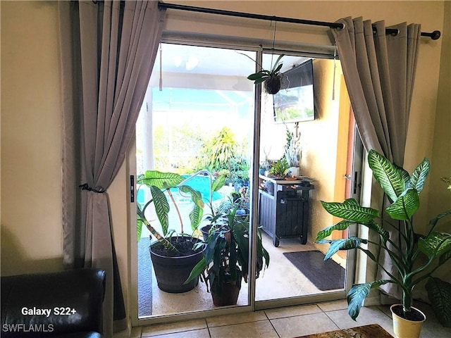 doorway to outside featuring light tile patterned floors