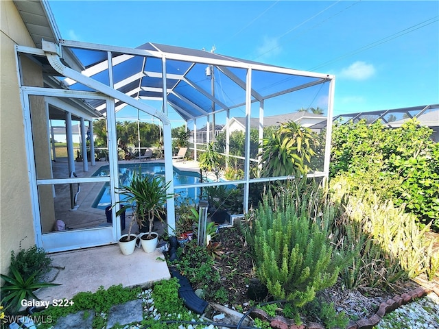 view of patio with glass enclosure