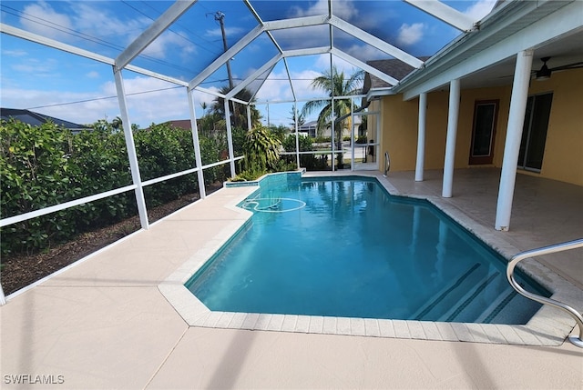 view of pool featuring ceiling fan, a lanai, and a patio