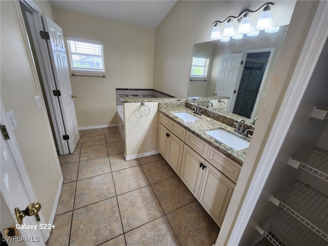 bathroom with vanity, a bathing tub, and tile patterned floors