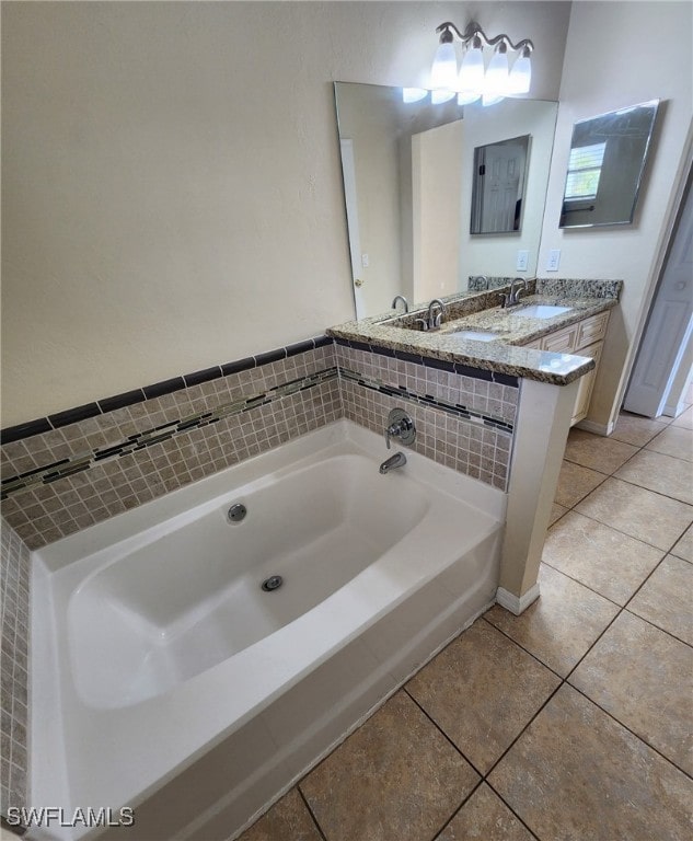 bathroom featuring vanity, tile patterned floors, and a tub