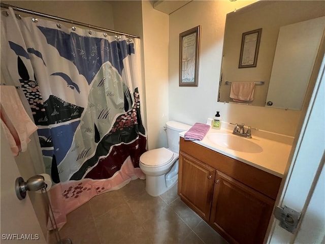 bathroom with tile patterned floors, vanity, curtained shower, and toilet