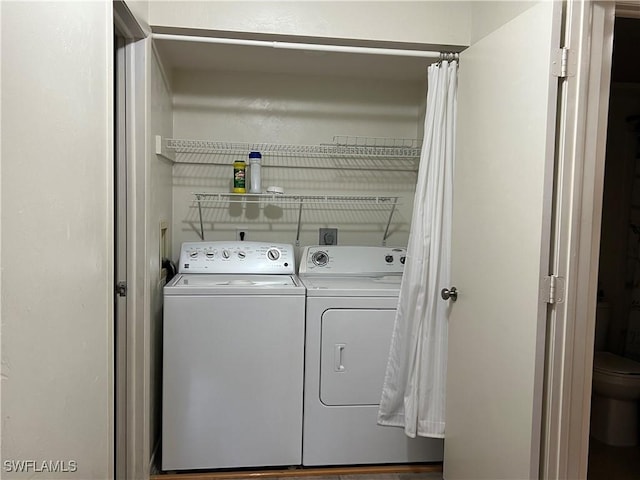 clothes washing area with washer and clothes dryer