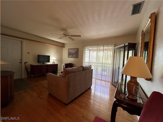 living room featuring hardwood / wood-style flooring and ceiling fan