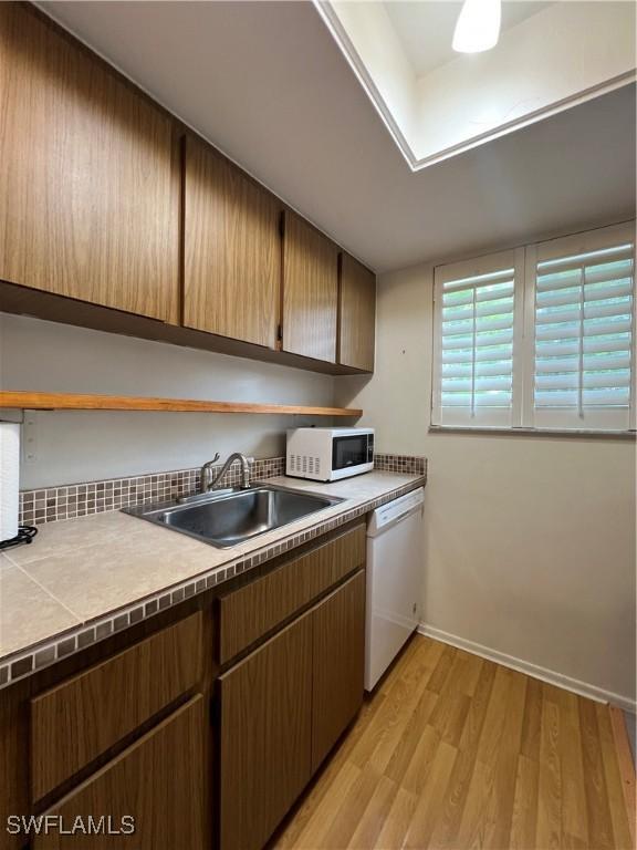 washroom with light wood-type flooring and sink