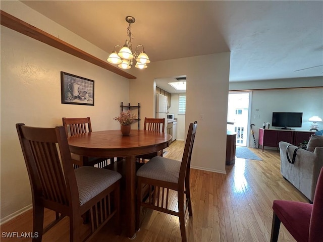 dining space featuring a chandelier and light hardwood / wood-style floors