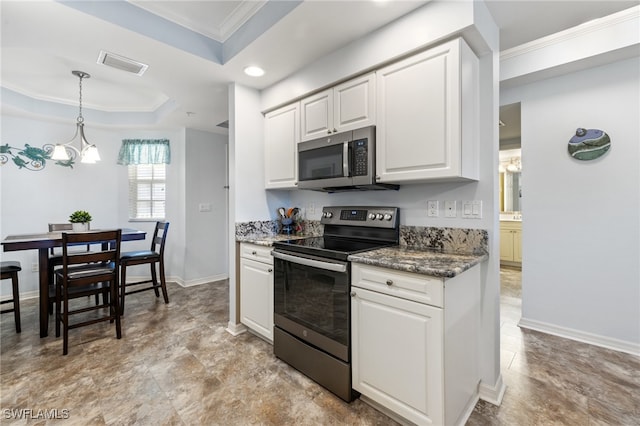 kitchen featuring appliances with stainless steel finishes, a raised ceiling, crown molding, a notable chandelier, and white cabinetry