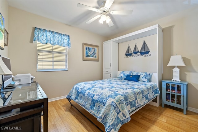 bedroom with ceiling fan and light wood-type flooring