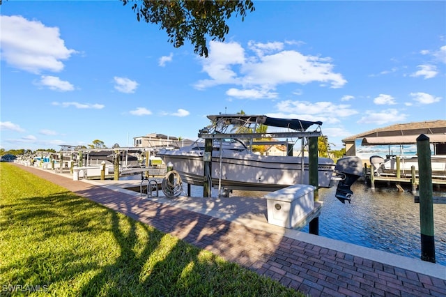 dock area featuring a lawn and a water view