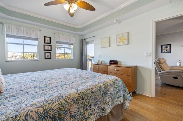 bedroom with light hardwood / wood-style flooring, ceiling fan, and ornamental molding