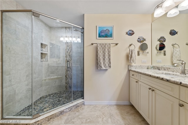 bathroom featuring vanity and a shower with shower door