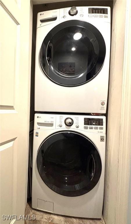 laundry room with stacked washing maching and dryer