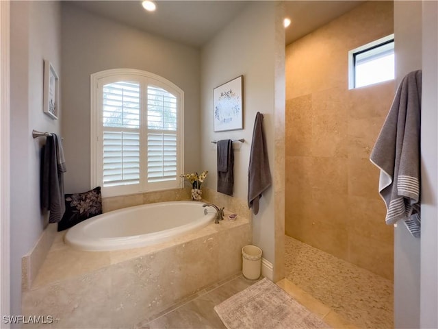 bathroom featuring shower with separate bathtub and tile patterned flooring