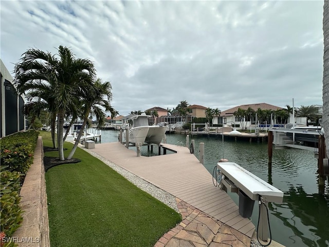 view of dock featuring a yard and a water view