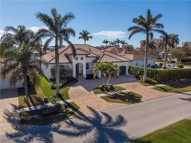 mediterranean / spanish home featuring a garage