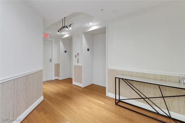 interior space with light hardwood / wood-style flooring and elevator