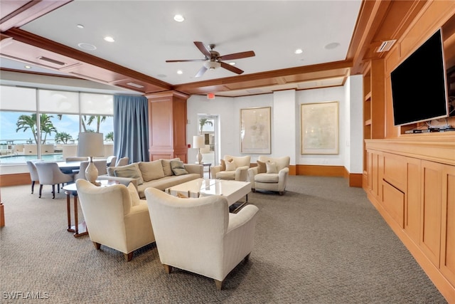 carpeted living room with ceiling fan and ornamental molding