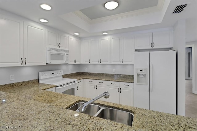 kitchen featuring sink, white cabinets, a tray ceiling, and white appliances