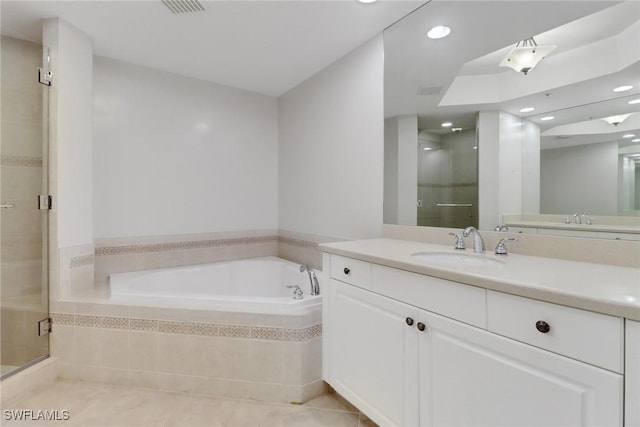 bathroom featuring vanity, tile patterned floors, and shower with separate bathtub