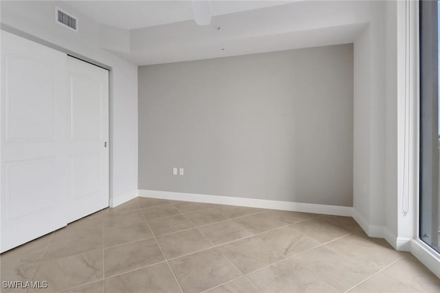 unfurnished bedroom with ceiling fan, light tile patterned floors, and a closet