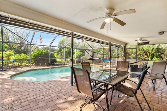 view of swimming pool featuring a patio, ceiling fan, and a lanai