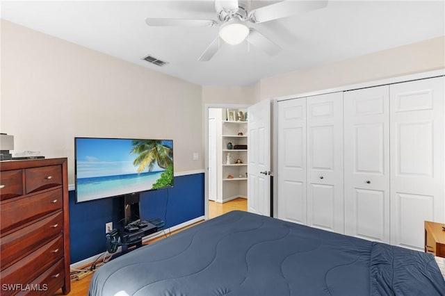 bedroom with ceiling fan, a closet, and light hardwood / wood-style flooring