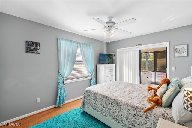 bedroom with multiple windows, ceiling fan, and wood-type flooring