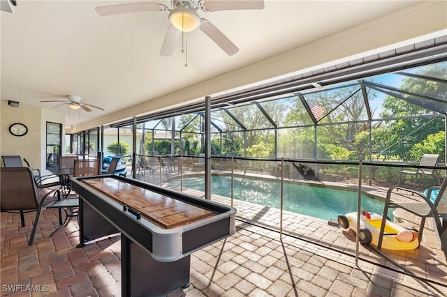 view of pool featuring ceiling fan, a patio area, and glass enclosure