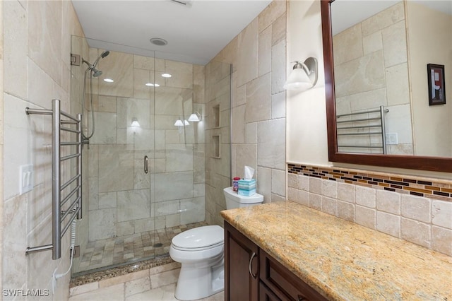 bathroom featuring decorative backsplash, vanity, toilet, and an enclosed shower