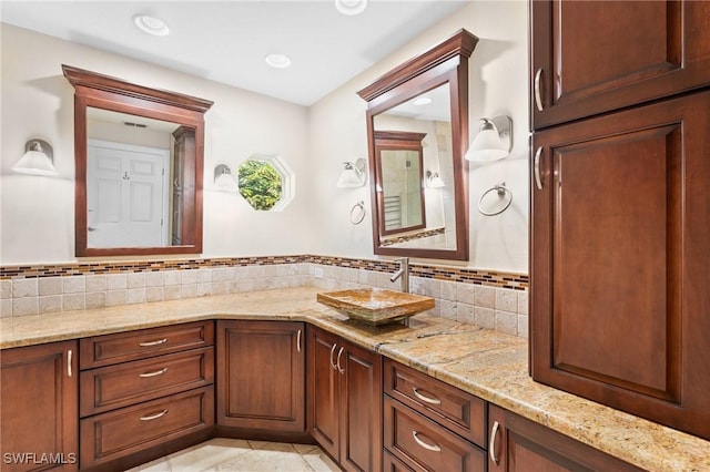 bathroom with tile patterned floors, vanity, and tasteful backsplash