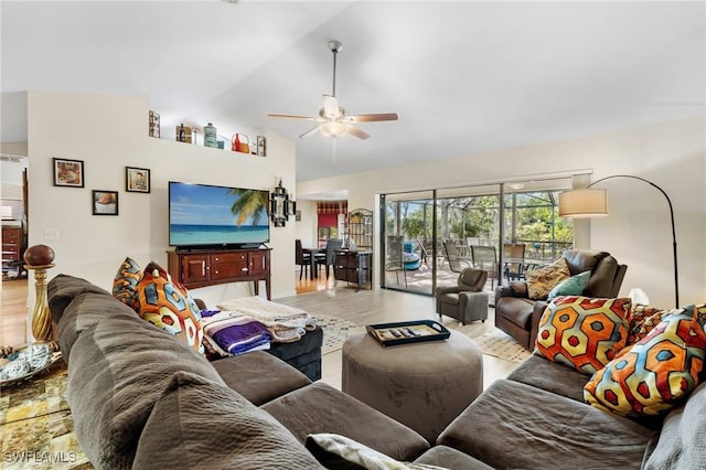 living room with hardwood / wood-style floors, ceiling fan, and vaulted ceiling