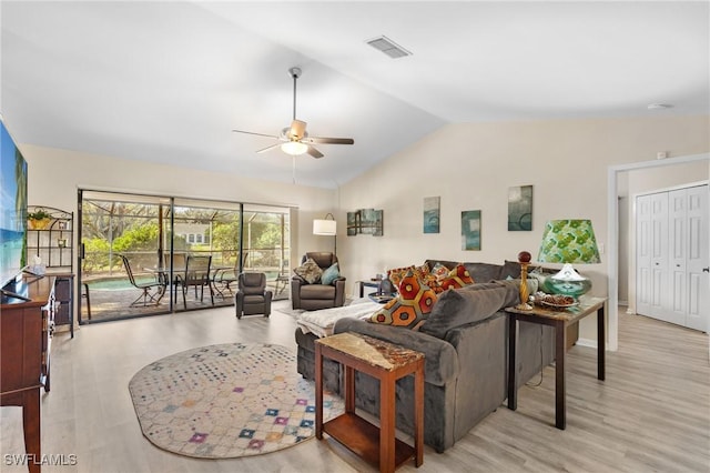 living room with light hardwood / wood-style flooring, ceiling fan, and lofted ceiling