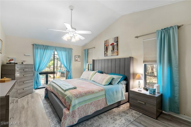 bedroom with access to exterior, ceiling fan, light hardwood / wood-style floors, and vaulted ceiling