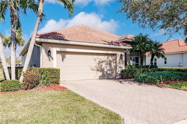 mediterranean / spanish-style home with a garage