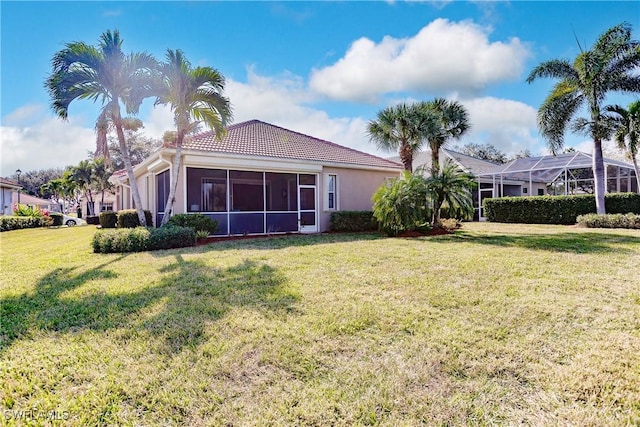 rear view of property with a lawn