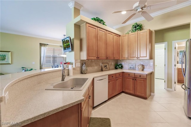 kitchen with sink, dishwasher, stainless steel refrigerator, backsplash, and crown molding