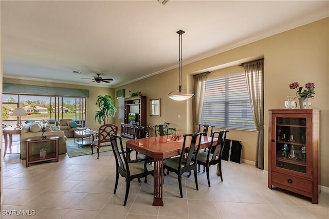 dining room with light tile patterned floors, ceiling fan, and crown molding