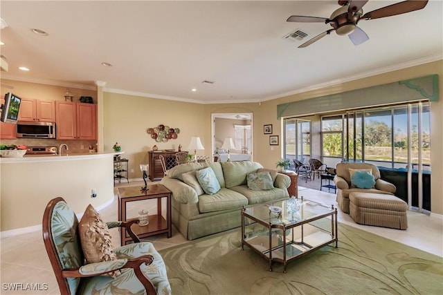 living room with ceiling fan, light tile patterned floors, and ornamental molding