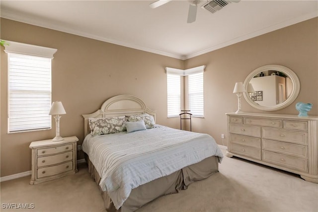 bedroom with ceiling fan, crown molding, and light colored carpet