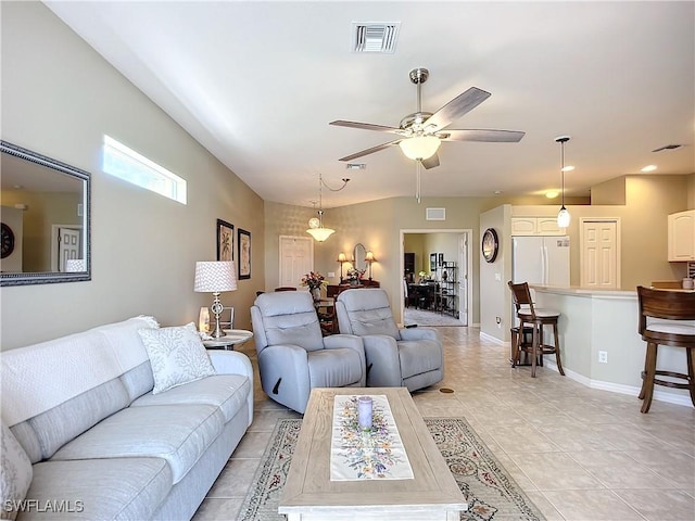 living area featuring a ceiling fan, visible vents, baseboards, and light tile patterned flooring