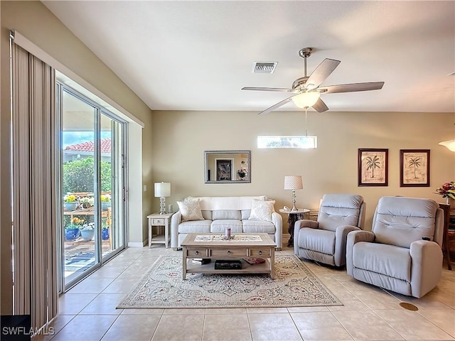 living room featuring light tile patterned floors, visible vents, and a ceiling fan