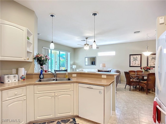 kitchen with hanging light fixtures, white appliances, open floor plan, and a sink