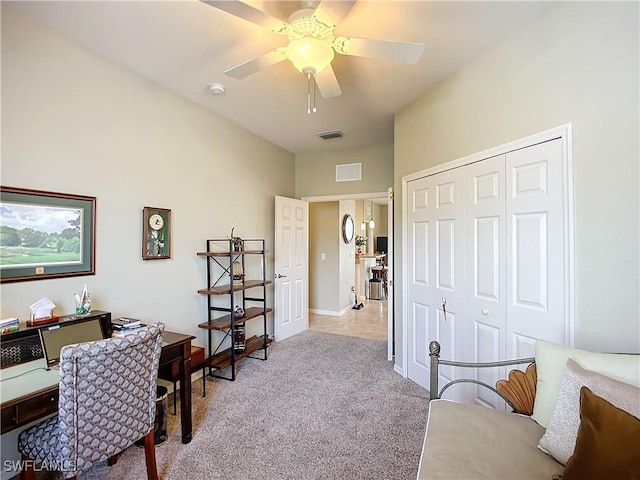 home office with a ceiling fan, light colored carpet, and visible vents