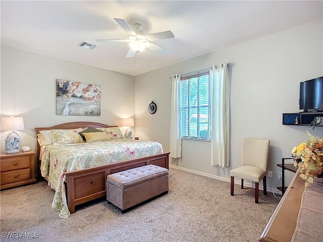 bedroom with baseboards, a ceiling fan, visible vents, and light colored carpet