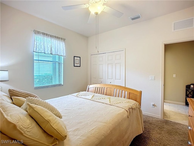 bedroom with ceiling fan, a closet, carpet, and visible vents