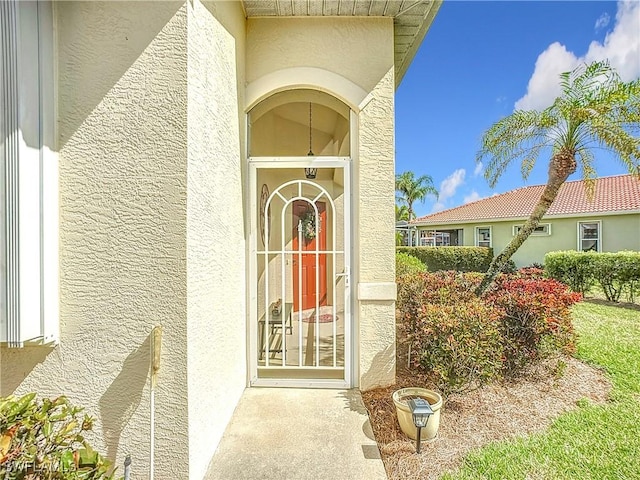 view of exterior entry with stucco siding