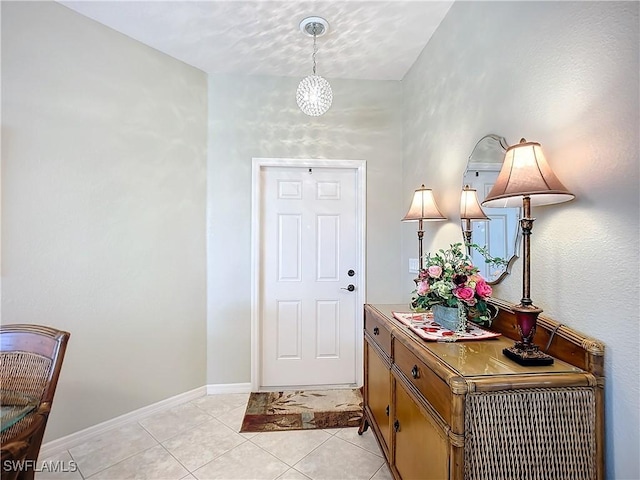 entrance foyer with baseboards and light tile patterned flooring