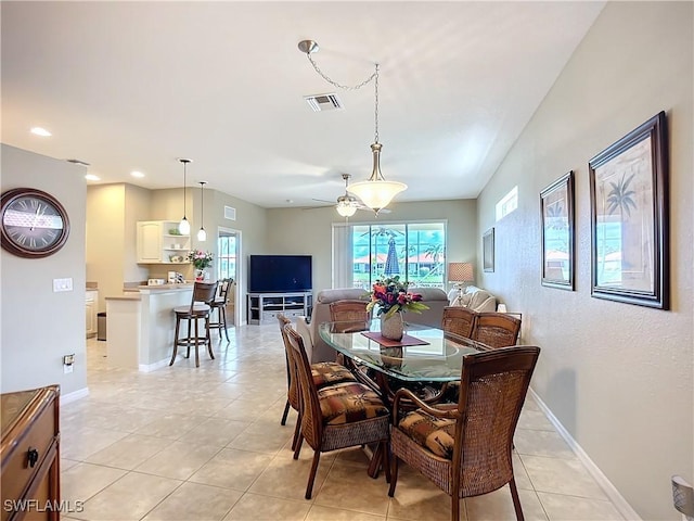 dining area with light tile patterned floors, baseboards, and visible vents