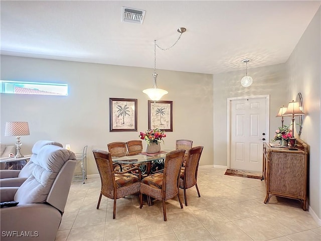 dining room with light tile patterned floors, visible vents, and baseboards